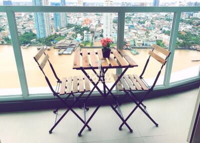 Balcony with city view featuring a wooden table and chairs