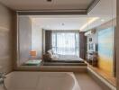 Modern bedroom with integrated bathroom design featuring a large bed, bathtub, and artistic decor