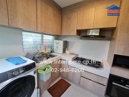 Modern kitchen with wooden cabinets and equipped with appliances