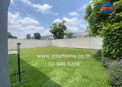 Spacious backyard with privacy fencing and lush green lawn