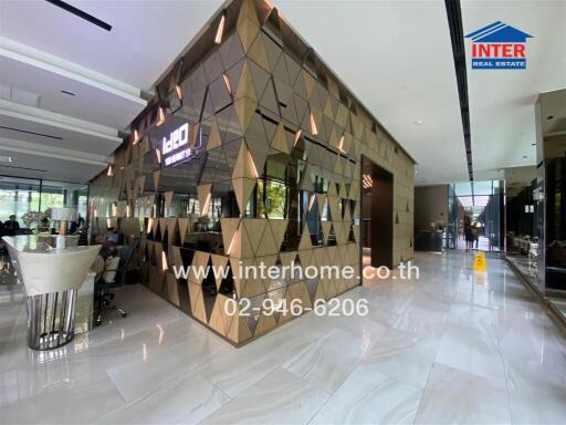 Modern and stylish commercial building lobby with mirrored geometric wall panels