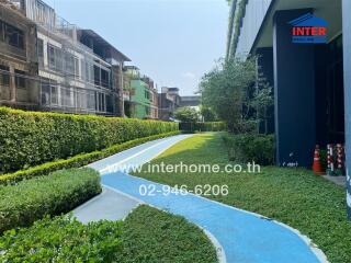 Beautiful outdoor path with green landscaping and colorful pavement in a residential property