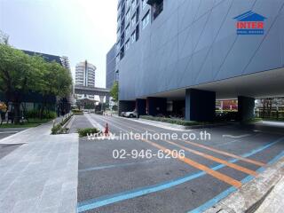 Modern building exterior with ample parking and landscaped approach