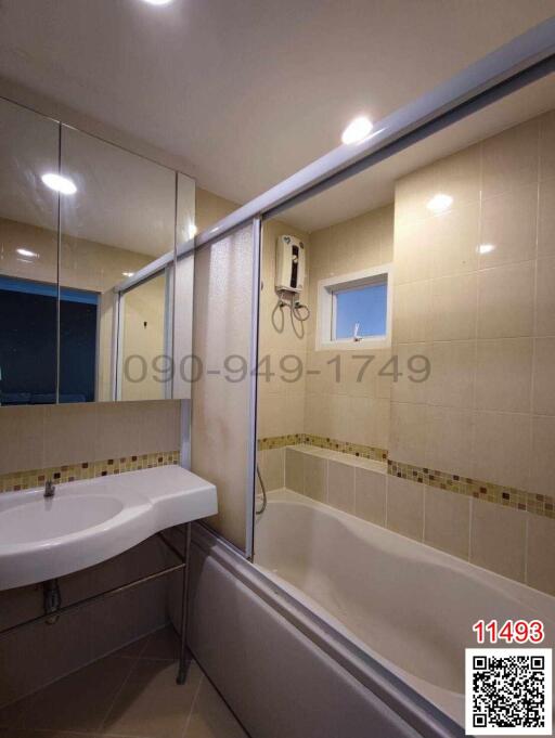 Spacious bathroom with modern fixtures and bathtub