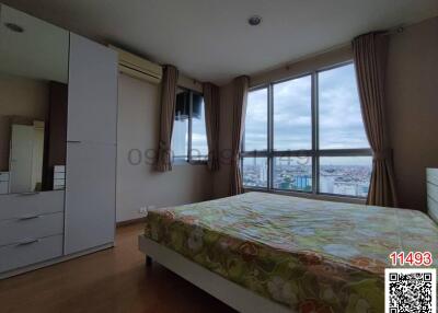 Spacious bedroom with large windows and city view