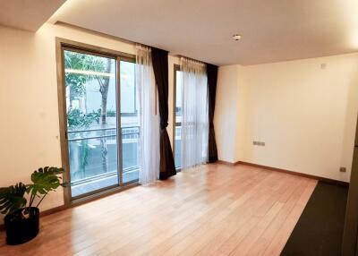 Spacious living room with large windows and balcony access
