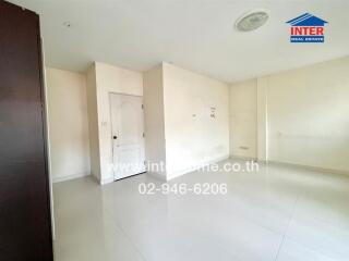 Spacious and bright living room with white walls and glossy floor tiles