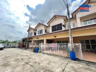 Exterior view of residential townhouses with parking space