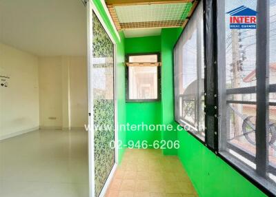 Bright sunroom with green walls and large windows