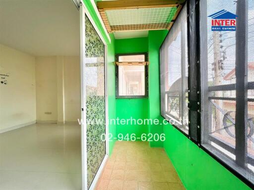 Bright sunroom with green walls and large windows