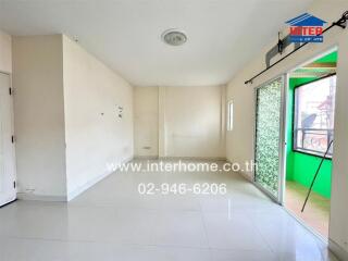 Bright and spacious empty bedroom with large windows and a balcony access