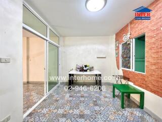 Bright sunroom with decorative tile flooring and brick wall