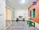 Bright sunroom with decorative tile flooring and brick wall