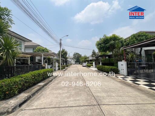 View of a peaceful residential street with modern homes and clear blue skies