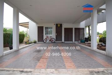 Covered parking area of a modern home with bicycle