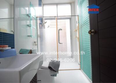 Bright and modern bathroom with glass shower and windows