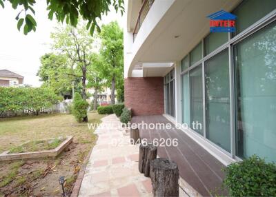 Front view of a modern house with garden and large windows