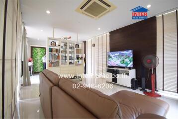 Spacious and well-lit living room with modern furniture and fittings