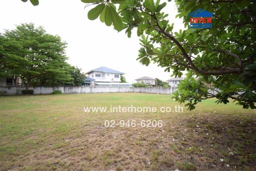 Spacious backyard of a residential property with a large grassy area and a view of a blue house