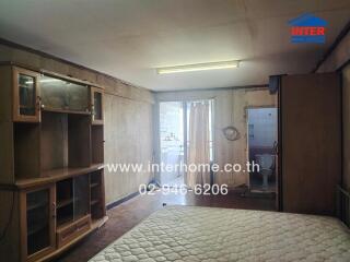Spacious bedroom with large bed and ample storage