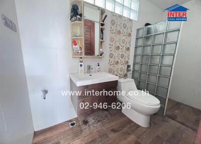 Well-lit bathroom with modern fixtures and decorative tiles