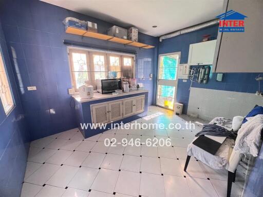Bright blue kitchen with white tiled floor