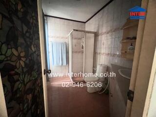 Brightly lit bathroom with traditional tiling and essentials