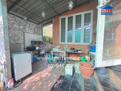 Spacious covered outdoor kitchen with appliances and storage