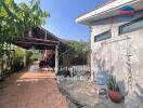 Spacious outdoor area with driveway and partial view of a home