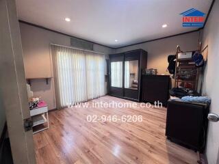 Spacious bedroom with large sliding door and ample natural light