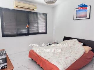 Spacious bedroom with air conditioning and large bed