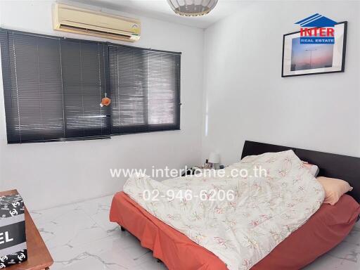 Spacious bedroom with air conditioning and large bed