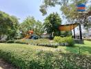 Lush community garden in a residential estate with playground and shaded sitting area