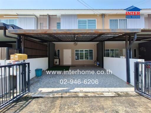 Facade view of a modern townhouse with carport