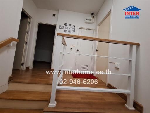 Modern hallway interior with wooden flooring and staircase