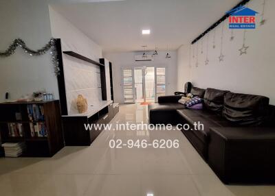 Spacious and well-lit living room with modern furnishings and balcony access