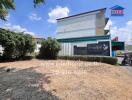 commercial building exterior with vacant land in front