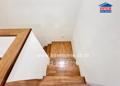 Modern wooden staircase leading downstairs in a residential home