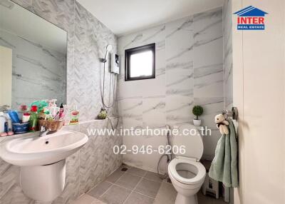 Modern bathroom with marble tiles and well-lit window