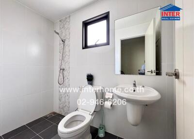 Modern bathroom with white fixtures and gray accents