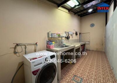 Spacious utility room with washing facilities and storage