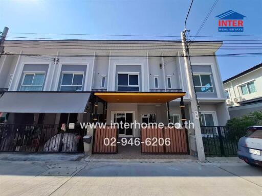 Modern two-story townhouse with a balcony and parking space