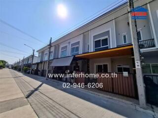 Exterior view of modern townhouses on a sunny day