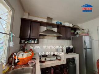 Spacious kitchen with dark wood cabinets and modern appliances