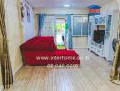 Bright and cozy living room with red sofa and access to balcony