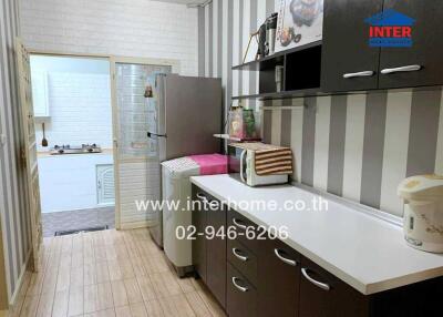 Compact and modern kitchen with appliances and striped wallpaper