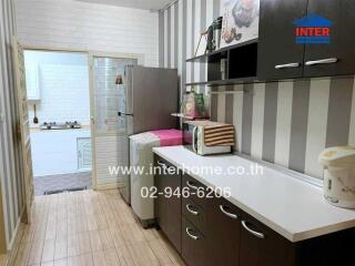 Compact and modern kitchen with appliances and striped wallpaper