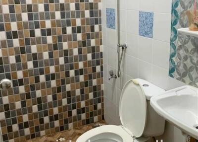Compact bathroom with tiled walls and flooring
