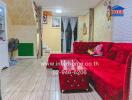 Cozy living room with red sofa and wooden flooring