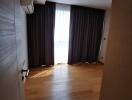 Spacious bedroom with hardwood floors and modern air conditioning unit